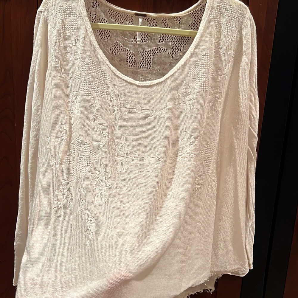 FreePeople cream color raw edge long sleeve pattern front top.